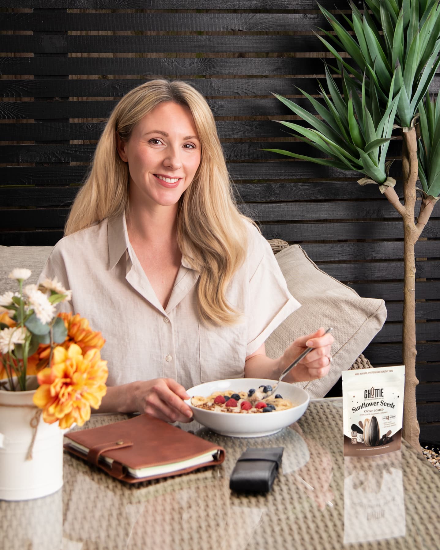 Lifestyle photo of Ghuttie Cacao Sunflower Seeds pouch in use