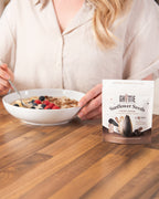 Lifestyle photo of Ghuttie Cacao Sunflower Seeds highlighting the cacao-coated seeds