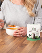 Lifestyle photo of Ghuttie Moringa Sunflower Seeds highlighting the moringa-coated seeds