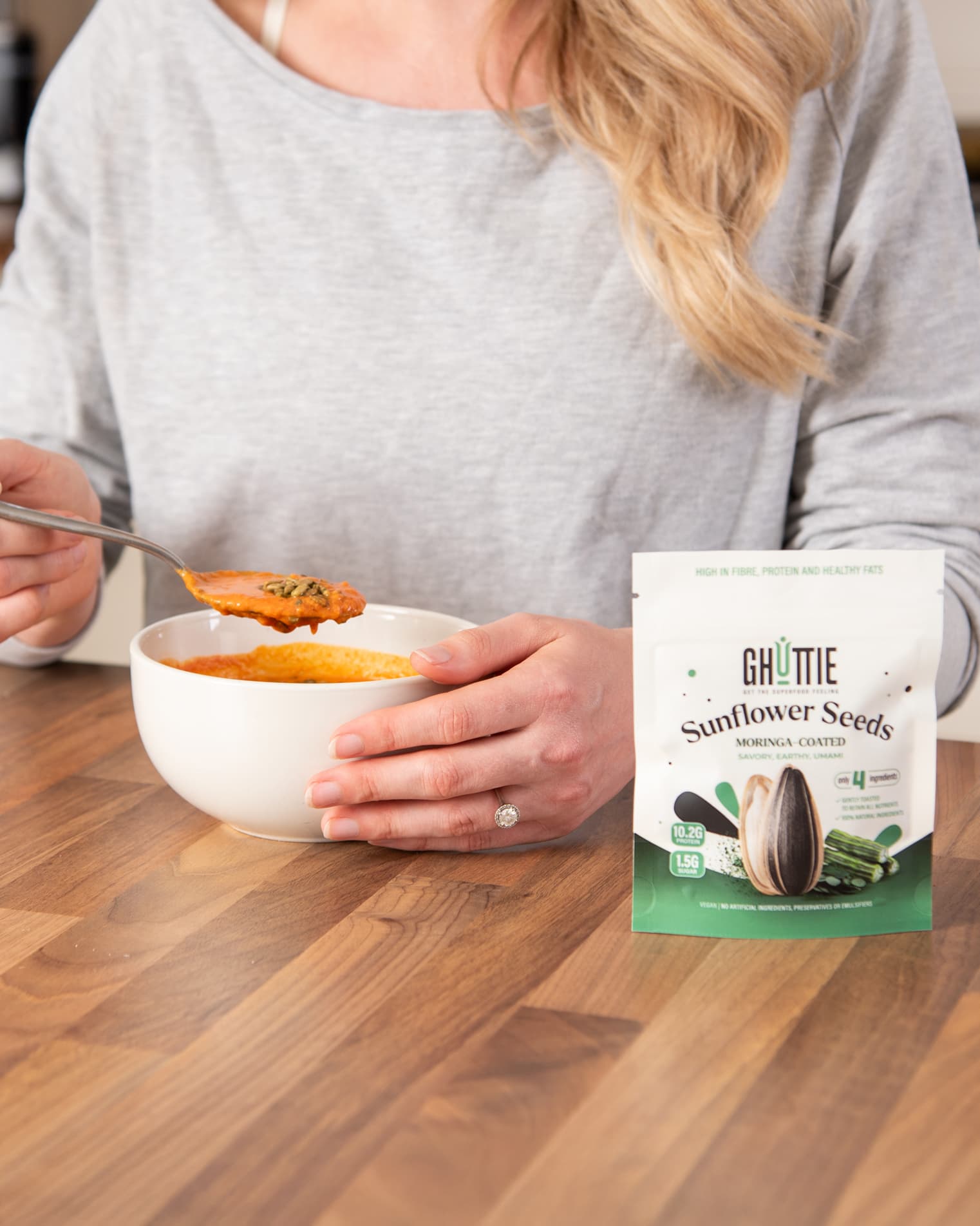 Lifestyle photo of Ghuttie Moringa Sunflower Seeds highlighting the moringa-coated seeds