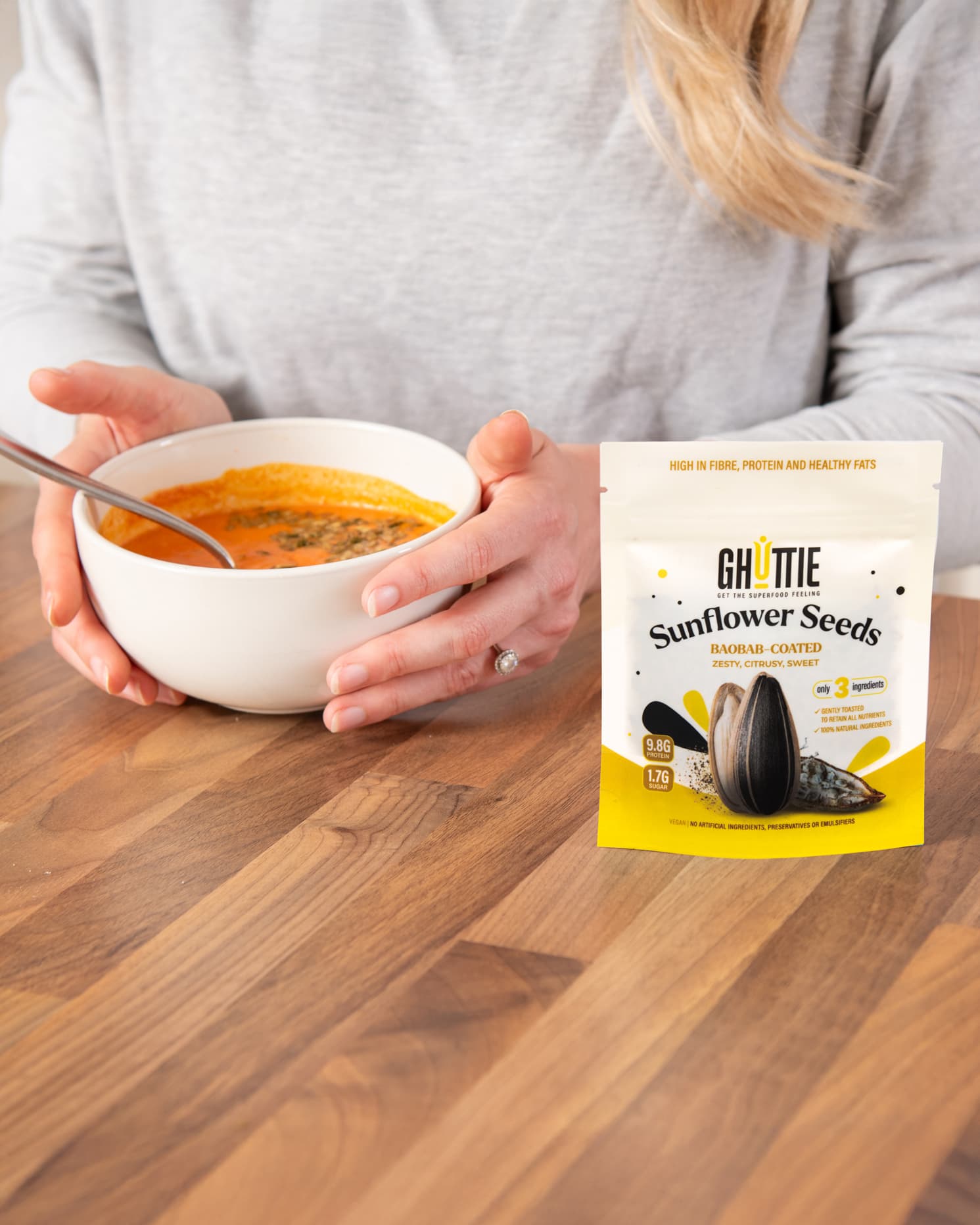 Lifestyle photo of Ghuttie Baobab Sunflower Seeds pouch in use